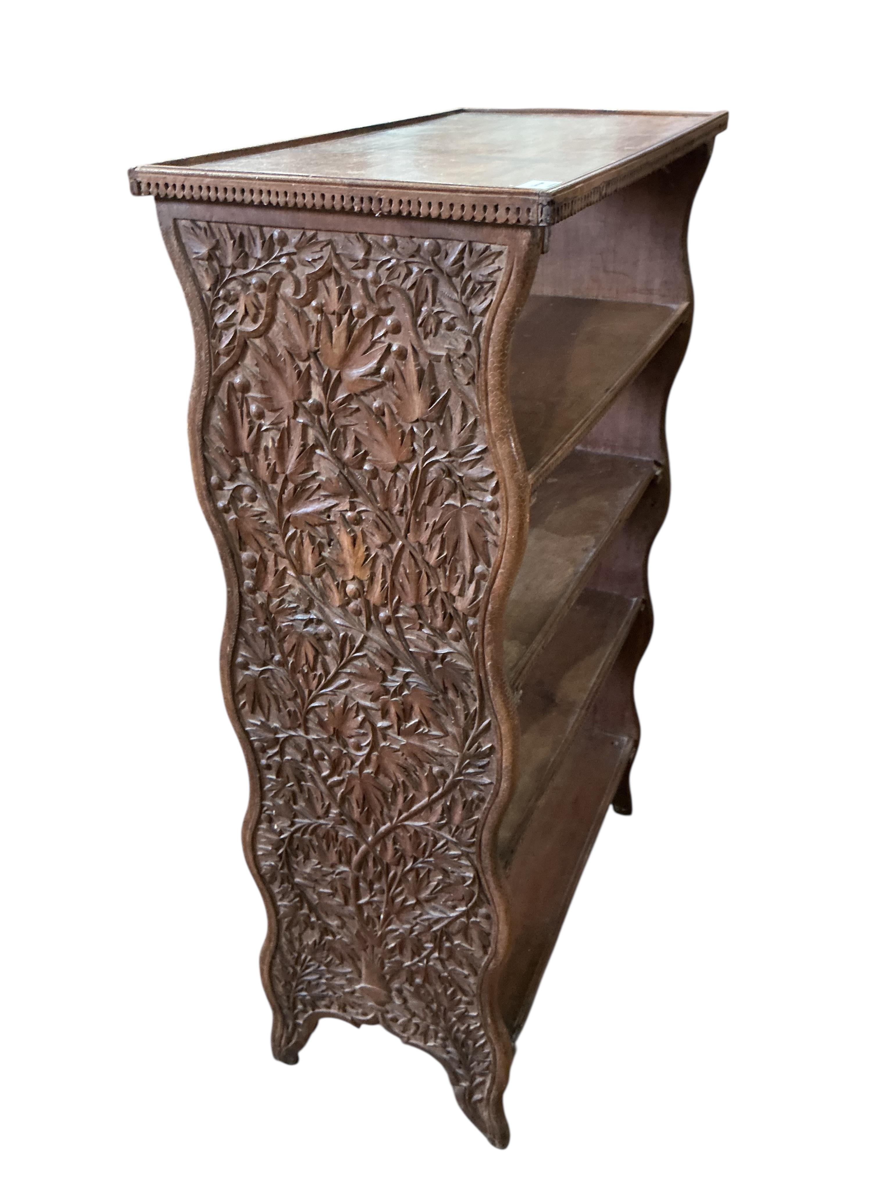 An Indian hardwood open bookcase, width 66cm, depth 34cm, height 107cm
